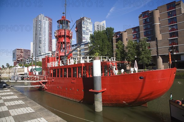 Historic red lightship floating restaurant and modern architecture Wijnhaven, Rotterdam, Netherlands