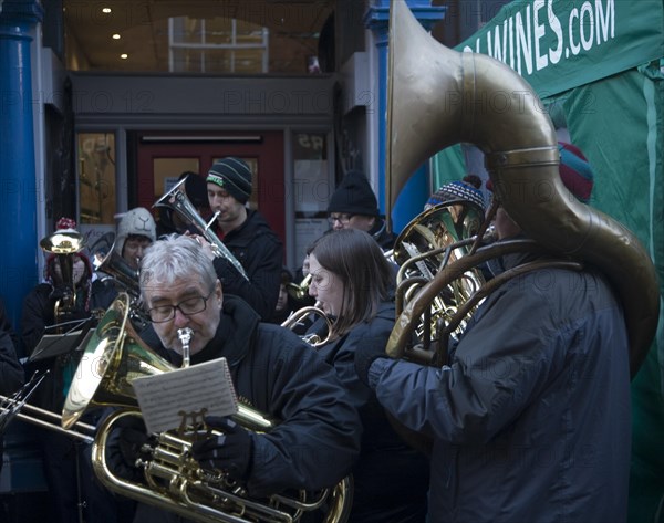 Brass band musicians perform at Christmas street fair, Woodbridge, Suffolk, England, United Kingdom, Europe