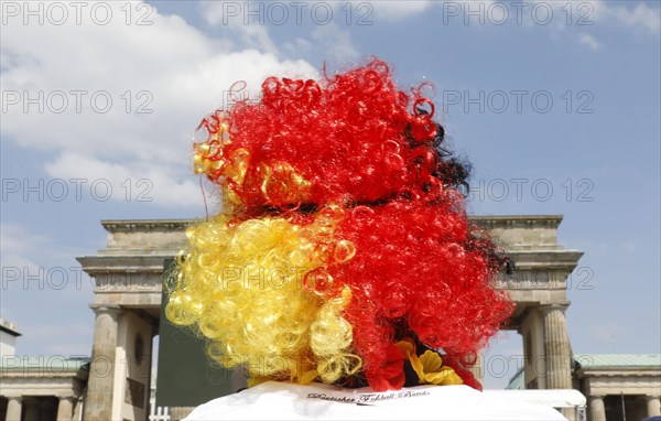 Football fan wears a wig with the colours of the German flag for the World Cup opening match between Germany and Mexico in the fan mile at the Brandenburg Gate in Berlin, 17.06.2018