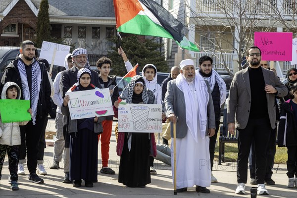 Hamtramck, Michigan USA, 25 February 2024, Two days ahead of Michigan's Presidential primary election, a rally in this heavily Arab-American city urges a vote for uncommitted instead of for Joe Biden. Abraham Aiyash (right), Majority Floor Leader in the Michigan State House of Representatives, joined the rally. Many Arab-Americans are furious about Biden's support for Israel in the Gaza war. Israel's bombing there has cost tens of thousands of Palestinian lives