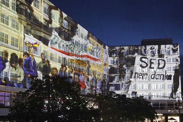 To mark the 30th anniversary of the fall of the Wall, 3D video projections of historical images and videos commemorate the events of the Peaceful Revolution and the opening of the Wall at original locations, such as here at Berlin's Alexanderplatz, 6 November 2019