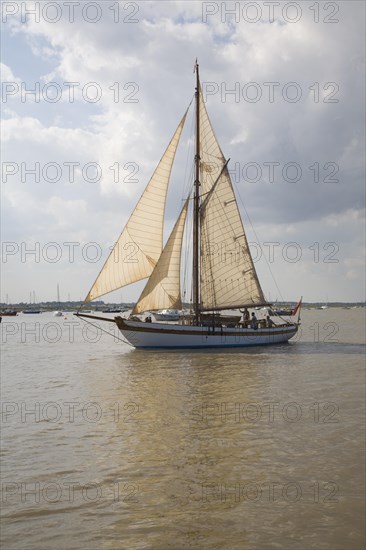 Historic wooden sailing yacht boat in full sail at the mouth of River Deben, Suffolk, England, United Kingdom, Europe