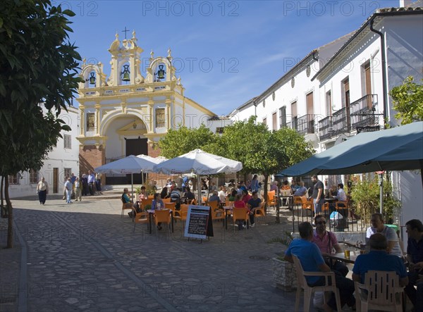 People gather in cafes and by the baroque church of San Juan at Zahara de la Sierra, Spain Sunday 13 October 2013 after the National Day holiday