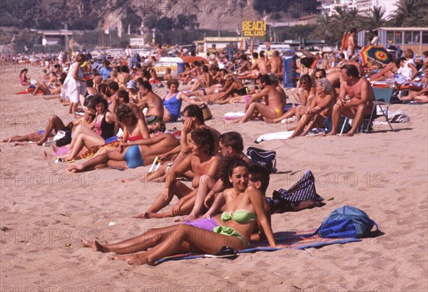 Crowded beach with sunbathers in Calella, Costa Brava, Barselona, Catalonia, Spain, Southern Europe. Scanned thumbnail slide, Europe