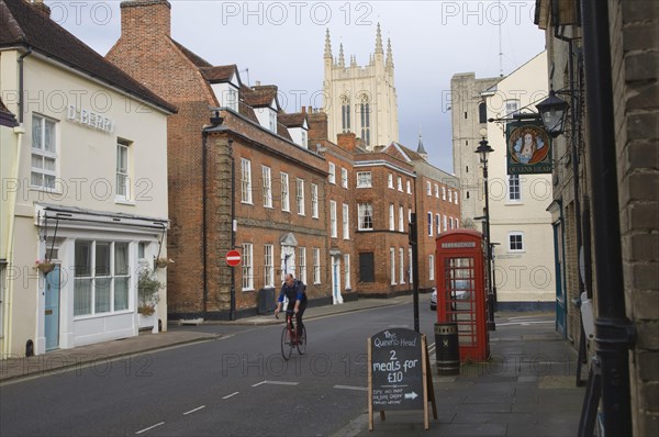 Tower of Saint Edmundsbury Cathedral above a street of historic buildings, Bury St Edmunds, Suffolk, England, United Kingdom, Europe