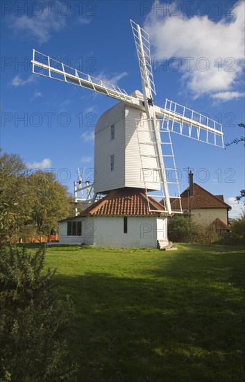 Thorpeness Windmill, Suffolk, England is a post mill built 1803 moved from Aldringham in 1923. It pumped water to the House in the Clouds seen in the background