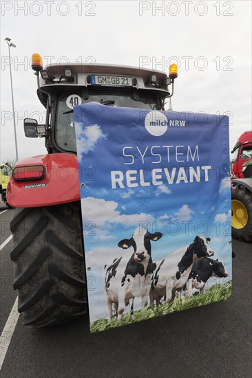 Poster with dairy cows and writing Systemrelevant on a tractor, farmer protests, demonstration against policies of the traffic light government, abolition of agricultural diesel subsidies, Duesseldorf, North Rhine-Westphalia, Germany, Europe