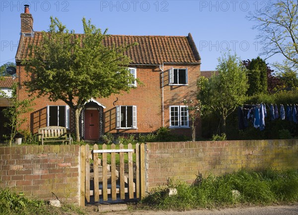 Property released picture of red brick detached house viewed from front wall and gate, Shottisham, Suffolk, England, United Kingdom, Europe