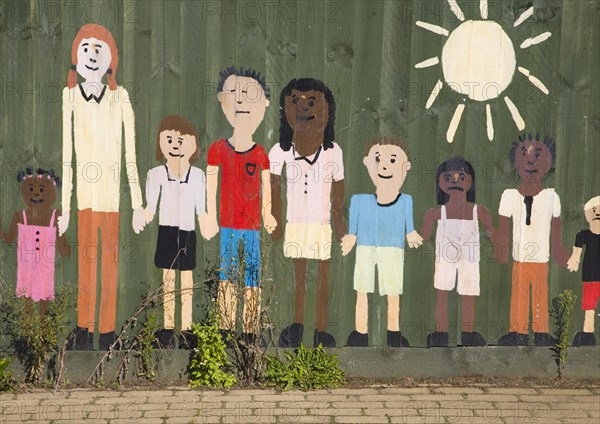 Painted collage picture of young children on a nursery school fence, Wickham Market, Suffolk, England, United Kingdom, Europe