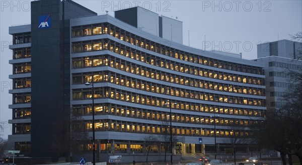 AXA insurance office illuminated by electric lights in winter afternoon, Ipswich, Suffolk, England, United Kingdom, Europe