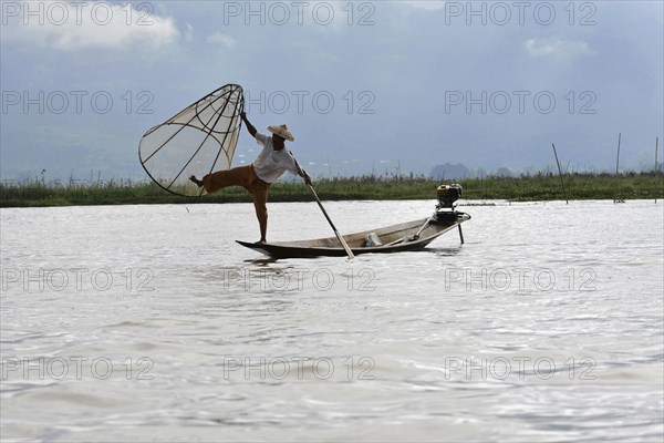 Intha fisherman, local man fishing with traditional conical fishing net, Inle Lake, Burma, Myanmar, Asia