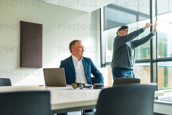 Businessmen wearing smart virtual glasses and joining business meeting on augmented reality metaverse working space