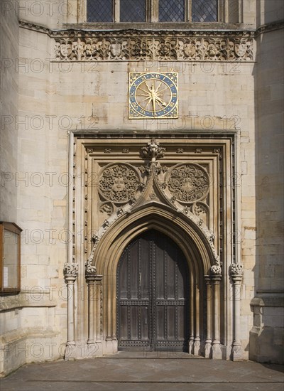 Ornate clock wooden doorway Church of St Mary the Great, Cambridge, England, United Kingdom, Europe