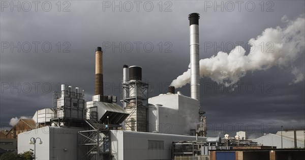 Steam rising from chimneys as sugar beet is processed at the British Sugar factory, Bury St Edmunds, Suffolk, England, United Kingdom, Europe