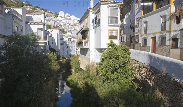 River running past whitewashed houses Setenil de las Bodegas, Cadiz province, Spain, Europe