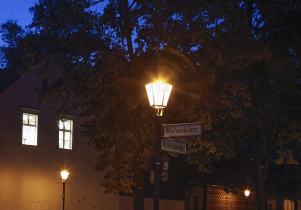 Old lanterns illuminate Richardplatz in Berlin's Neukoelln district. Richardplatz is the central square and village green of the former village of Rixdorf, which was divided into Deutsch-Rixdorf and Boehmisch-Rixdorf after 1737, 15 October 2019
