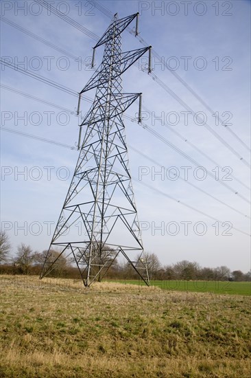 Electricity pylons crossing over countryside, Suffolk, UK