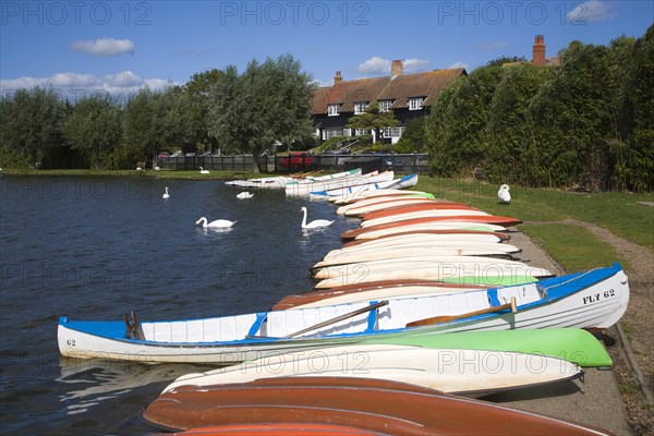 Colourful rowing boats on the Meare boating lake, Thorpeness, Suffolk, England, United Kingdom, Europe