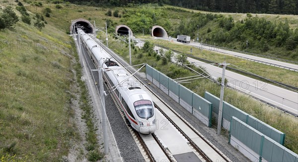 Two tunnels for cars on the A71 motorway, next to a tunnel with an ICE1 T train. The new Leipzig Erfurt line is a high-speed railway line between Erfurt and Nuremberg, Behringen, 19.06.2018