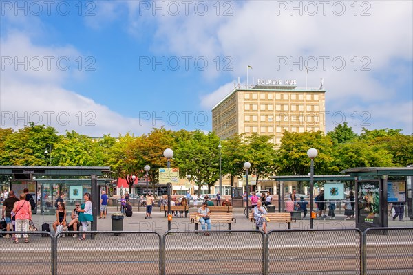 Bus and tram stop in a city with waiting people, Gothenburg, Sweden, Europe