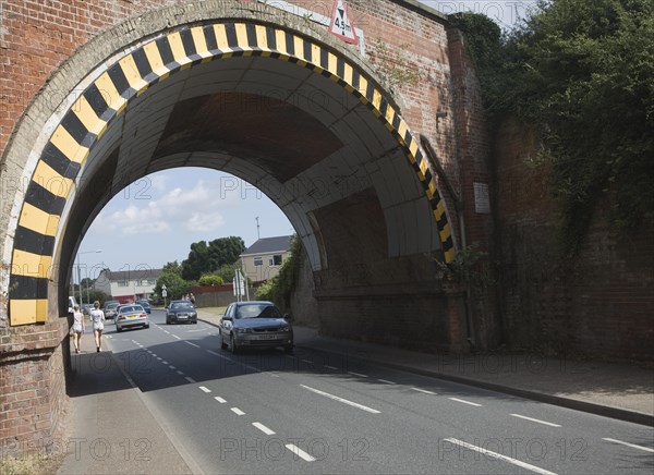 Warning paint over arch of low road bridge in Lawford, near Manningtree, Essex, England, United Kingdom, Europe