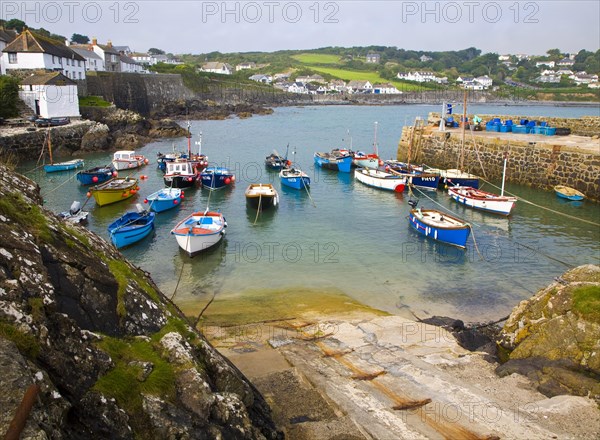 Small fishing boats in the harbour at the village of Coverack on the Lizard peninsula, Cornwall, England, United Kingdom, Europe