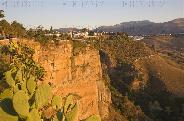 Historic buildings perched on sheer cliff top in Ronda, Spain, Europe