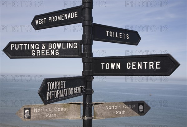 Direction arrow street signs pointing to seaside attractions, Cromer, Norfolk, England, United Kingdom, Europe