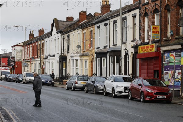 A man walks across a street near Liverpool FC's football stadium, 02/03/2019