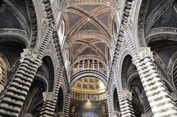 Black and white striped marble columns in the cathedral, cross and round arches, Siena, Tuscany, Italy, Europe