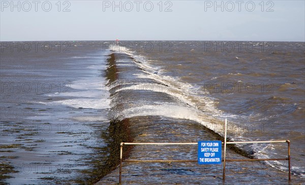 High seas forcing waves over the harbour mouth breakwater at Harwich, Essex, England, United Kingdom, Europe