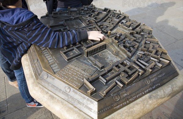 Child pointing at location on three dimensional model of the city centre, Cambridge, England, United Kingdom, Europe