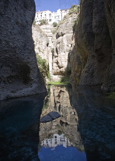 El Tajo canyon of the Rio Guadalevin river with white buildings perched on the cliff top, Ronda, Spain, Europe