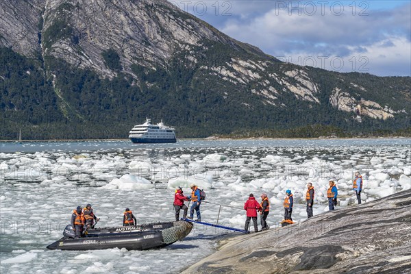 Passengers of the cruise ship Stella Australis board an inflatable boat between ice floes at Pia Glacier, Alberto de Agostini National Park, Avenue of Glaciers, Chilean Arctic, Patagonia, Chile, South America