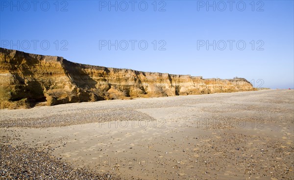 Rapid coastal erosion of soft cliffs between Benacre and Kessingland on the Suffolk coast England. The cliffs were formed by glacial outwash of sands and pebbles which overly older clay strata. This structure of permeable rock over impermeable clay makes the cliff especially prone to slumping and mass movement