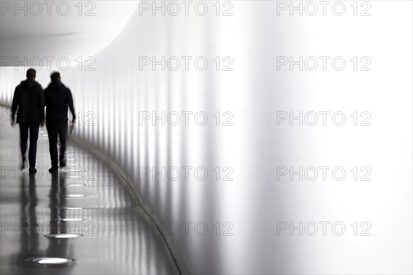 Members of the German Bundestag walk through a tunnel. The tunnel connects the Reichstag and the Paul Loebe Haus, Berlin, 13 November 2018