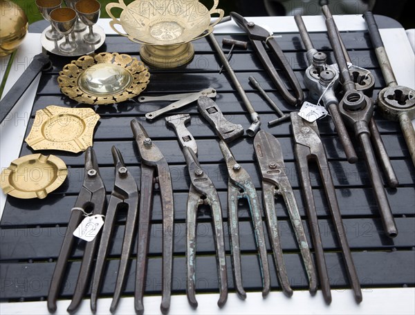 Old metal tools on display at a car boot sale, UK