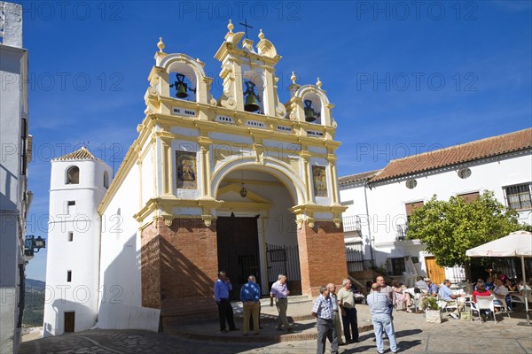 People gather by the baroque church of San Juan at Zahara de la Sierra, Spain Sunday 13 October 2013 after the National Day holiday