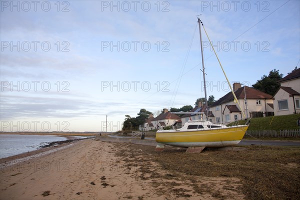 Sailing boat dumped on beach by winter storm surge December 2013, Bawdsey, Suffolk, England, United Kingdom, Europe