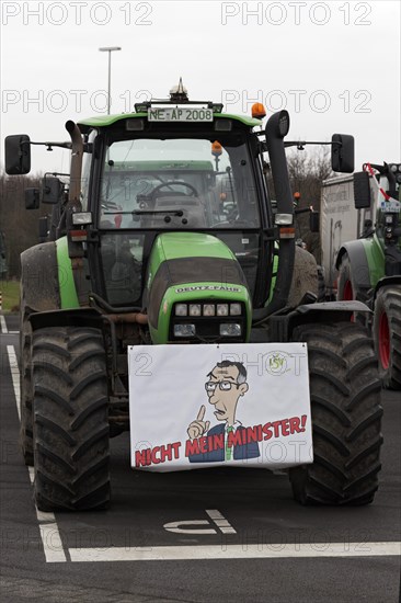 Sign with drawn Minister of Agriculture Cem Oezdemir on a tractor, farmer protests, demonstration against policies of the traffic light government, abolition of agricultural diesel subsidies, Duesseldorf, North Rhine-Westphalia, Germany, Europe