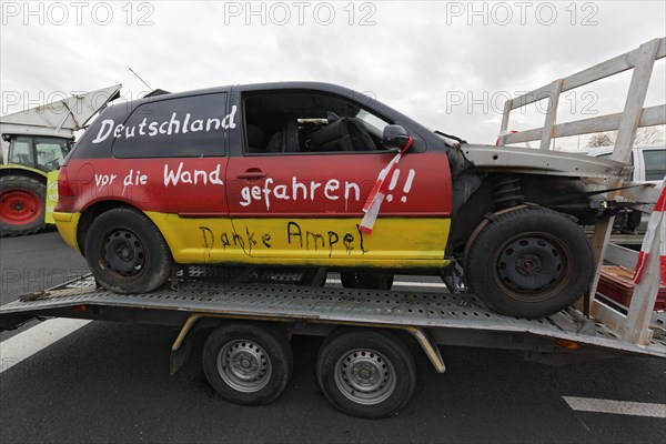 Accident car painted in Germany colours, with the inscription Deutschland vor den Wand gefahren, farmers' protests, demonstration against the policy of the traffic light government, abolition of agricultural diesel subsidies, Duesseldorf, North Rhine-Westphalia, Germany, Europe
