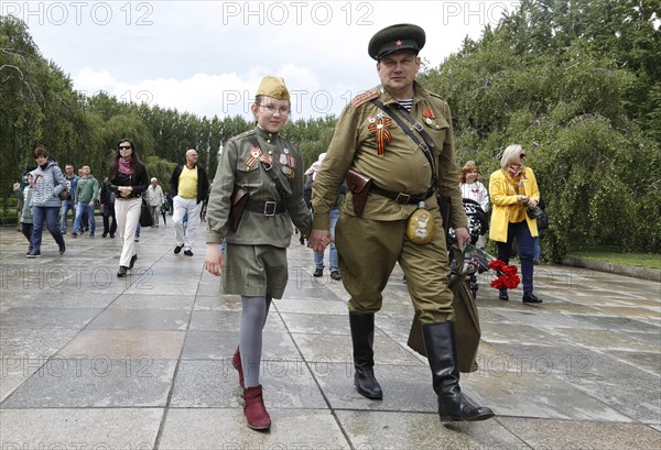 Men in Russian uniforms walk to the Russian memorial in Treptower Park in Berlin on the 74th anniversary of the victory of Russia over Germany, 09.05.2019