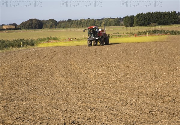 Farm machinery spraying Glyphosate herbicide on an arable field near Hollesley, Suffolk, England, United Kingdom, Europe