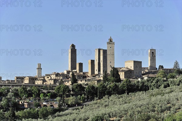 Town view, town scape, cityscape of San Gimignano in autumn, gender towers, countryside, in fall, fields of olive trees, wineyards, Tuscany, Italy, Europe