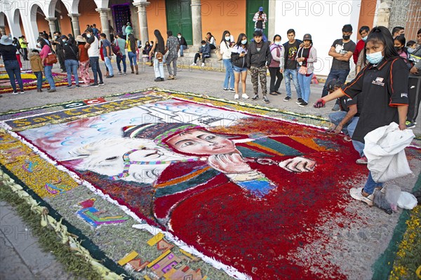 Peruvian woman making a floor painting in the Plaza de Armas, spectators watching, Ayacucho, Huamanga province, Peru, South America