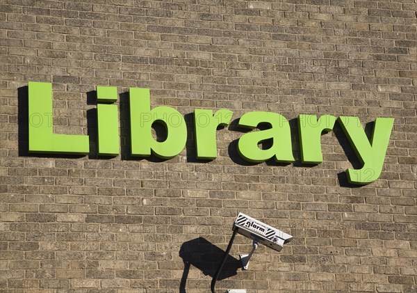 Green lettering sign for Library with CCTV camera