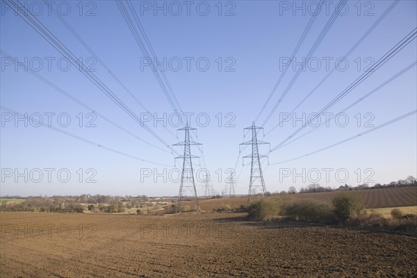 Electricity pylons and transmission lines cross countryside, Claydon, Suffolk, England, United Kingdom, Europe