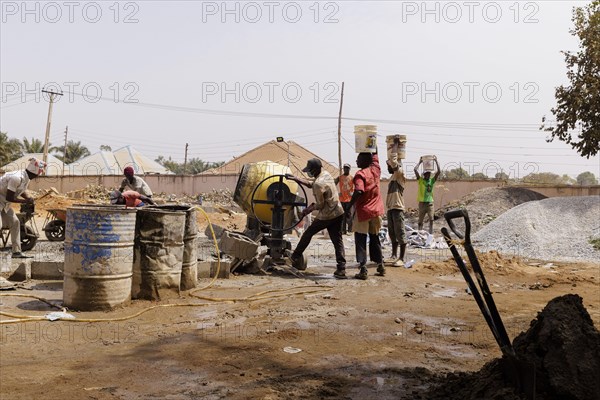Young men working on a construction site in Nigeria, 06.02.2024