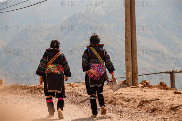 Women from the Hmong tribe wearing their traditional clothes while walking back to Lao Cai Village in Sa pa, Vietnam, Asia