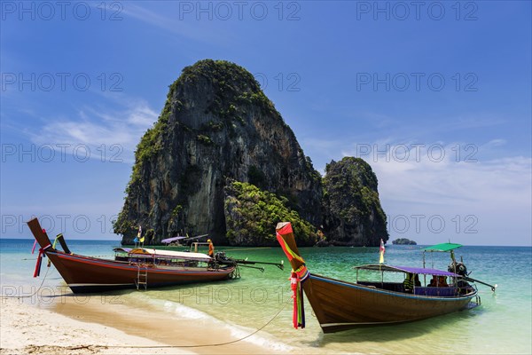 Longtail boat, fishing boat, wooden boat, boat, decorated, tradition, traditional, faith, cloth, colourful, bay, sea, ocean, tropical, tropical, island, water, beach, beach holiday, Caribbean, environment, peaceful, picturesque, sea level, climate, travel, tourism, paradisiacal, beach holiday, sun, sunny, holiday, dream trip, holiday paradise, paradise, coastal landscape, nature, idyllic, turquoise, Siam, exotic, travel photo, sandy beach, seascape, limestone, rocks, limestone cliffs, Krabi, Thailand, Asia
